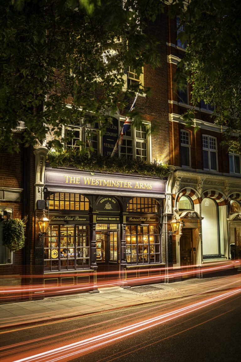 The Westminster Arms pub in London at night with car light trails