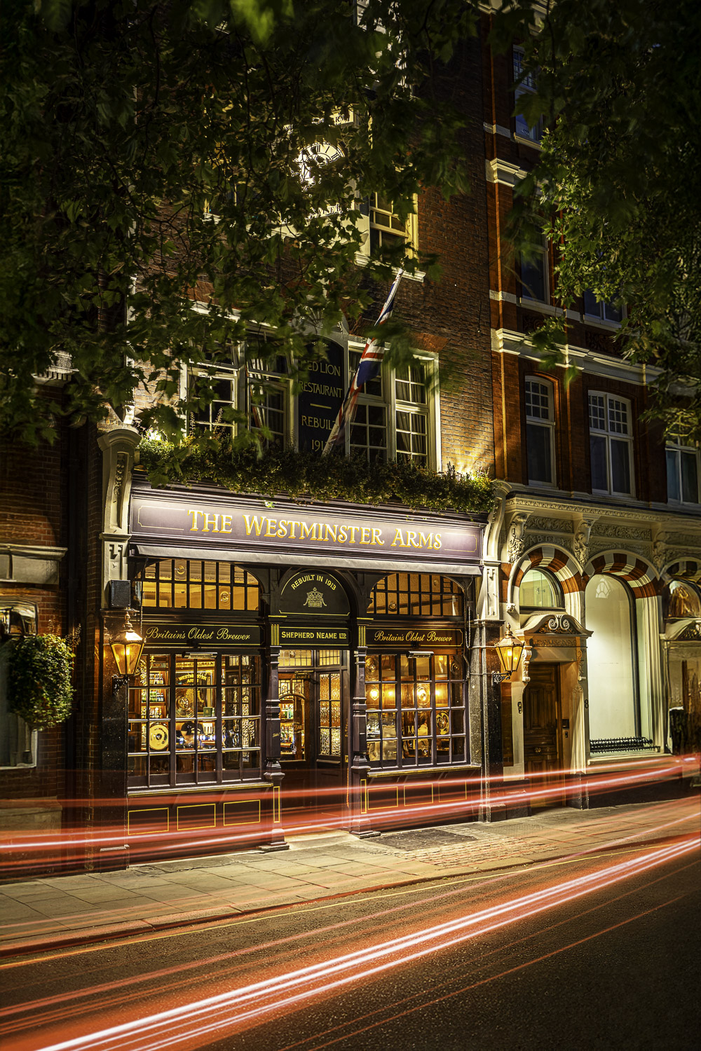 The Westminster Arms pub in London at night with car light trails