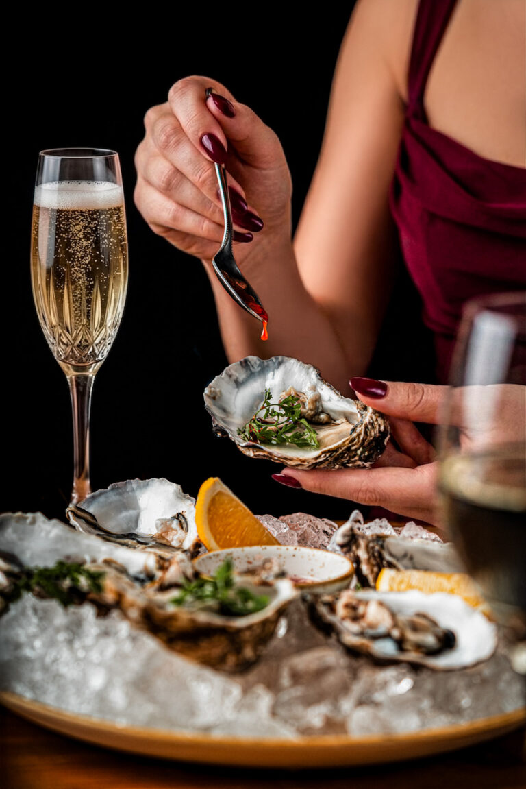 Fresh oysters on ice with citrus and champagne in an elegant fine dining setting