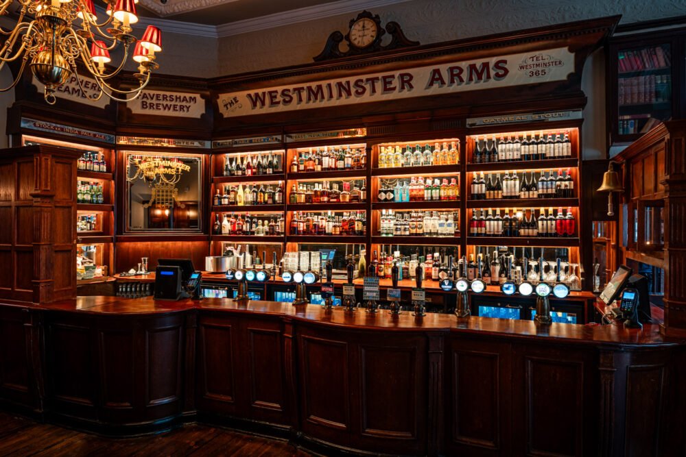 Traditional pub back bar with whisky shelves, spirits display and beer pumps